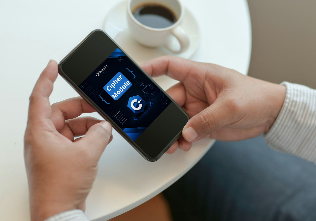 Person holding a smartphone with an app on the screen, next to a cup of coffee on a table.